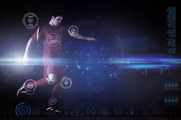 Wall Mural - Composite image of football player in red kicking