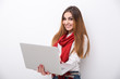 © Drobot Dean - Smiling woman standing with laptop and looking at the camera