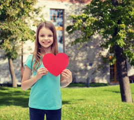 Canvas Print - smiling little girl with red heart