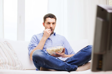 Sticker - man watching tv and eating popcorn at home