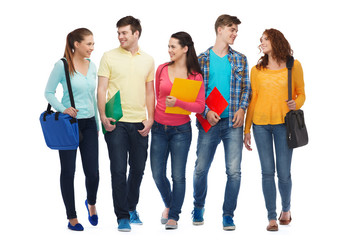 group of smiling teenagers with folders and bags