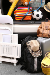 Wall Mural - Suitcases and bags in trunk of car ready to depart for holidays