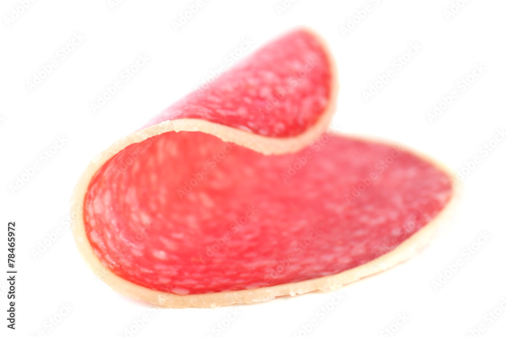 Slice of salami isolated on white background