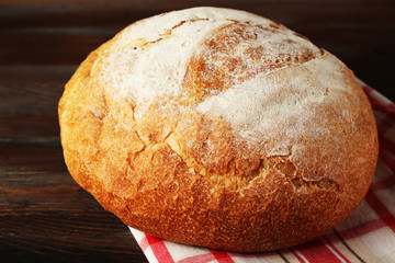 Poster - Fresh bread on napkin on wooden background