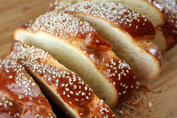 Poster - Sliced fresh bun on wooden background