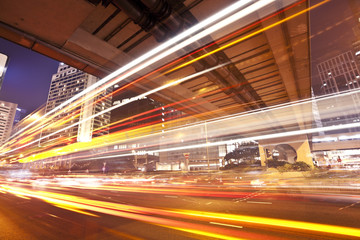 Traffic trails of double decker traveling on a busy road