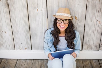 Poster - Pretty hipster sitting on ground with tablet