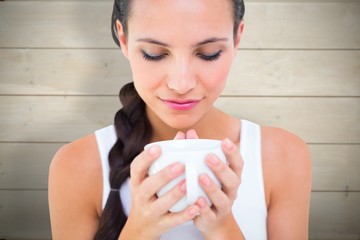 Poster - Composite image of pretty brunette having cup of tea