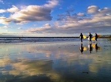 Three Surfers At Dog Beach, Ocean Beach, San Diego, CA, USA