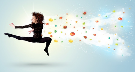 Beautiful woman jumping with colorful gems and crystals on the b