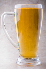 full glass of beer on stone background