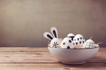 Wall Mural - Easter eggs with hand drawing ornament on wooden table