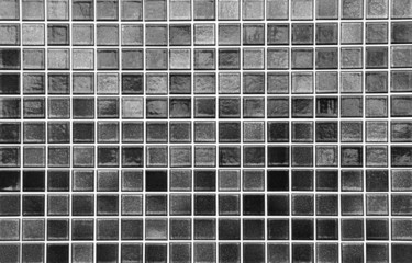 Black mosaic tile wall seamless background and texture