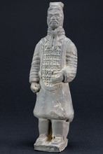 Gray Oriental Man Statuette Over Black Background