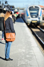 Woman Waiting For Incoming Train