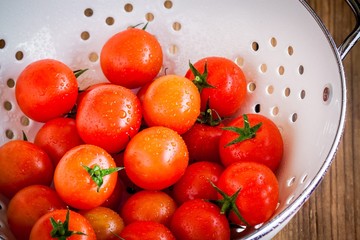 Wall Mural - fresh organic ripe cherry tomatoes with drops in white colander