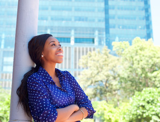 Friendly smiling business woman outside office building