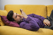 © theartofphoto - Attractive young man recording voice message on cell phone