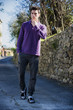 © theartofphoto - Handsome young man walking along rural road