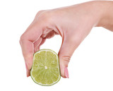 Fototapeta Mapy - Female hand squeezing lime isolated on white