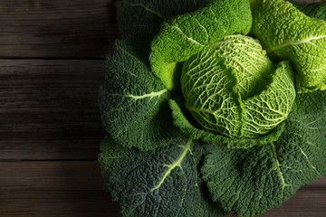 Savoy cabbage superfood on dark wooden background