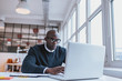 © Jacob Lund - Businessman working on laptop in office