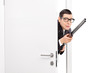 Terrified man with rifle entering a room
