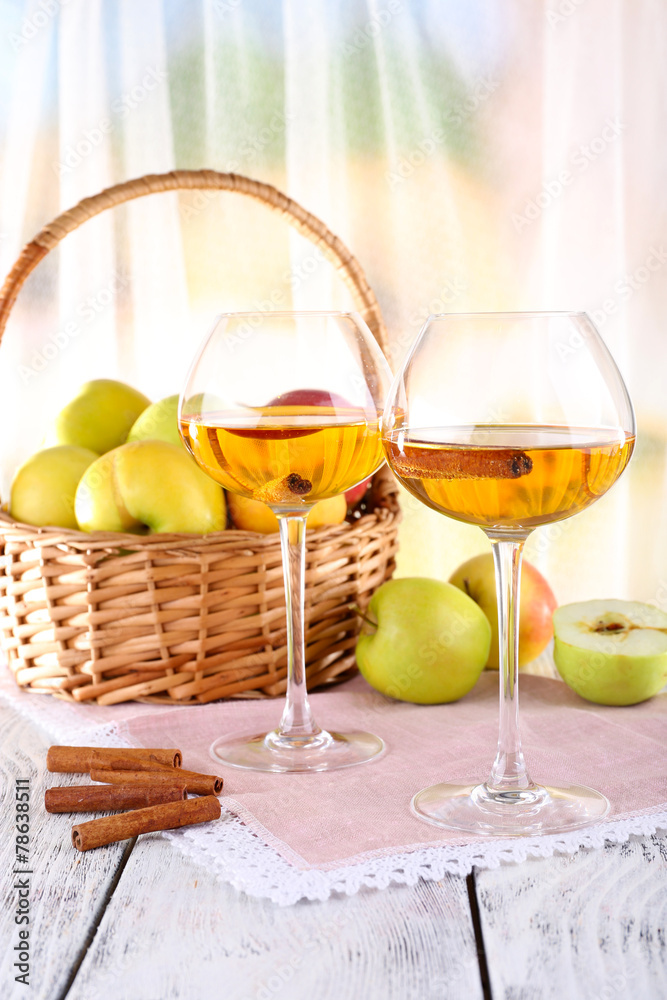 still life with apple cider and fresh apples on wooden table