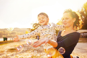 Mom and son having fun by the lake