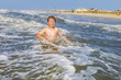 © travelview - boy enjoying the beautiful ocean and beach