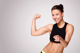 Mixed race woman demonstrating biceps