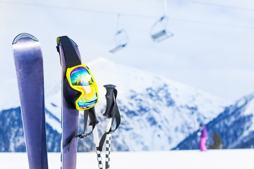 Ski with mask and pole, chairlift on background