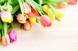 Bunch of tulips on white wooden background