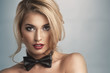 Black bowtie worn by a model with red lips.