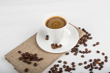 Coffee cup and beans on a white background.