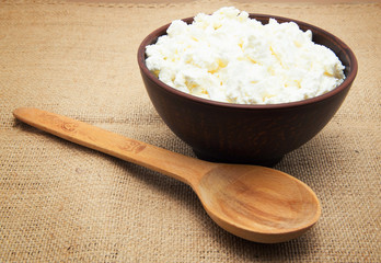 curd in brown bowl on sacking