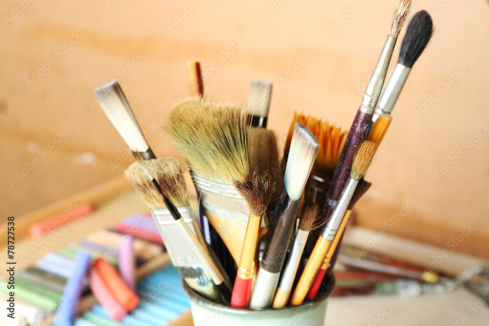Paintbrushes with colorful chalk pastels in box