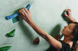 © Alex Photo - Girl climbing up on rock wall indoor