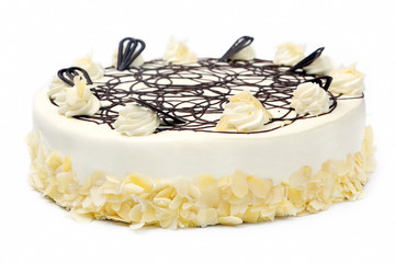 Wall Mural - Cream almond cake with chocolate icing on white background