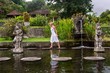 © esteldance - Young women near Water Palace Tirthagangga. Bali Indonesia