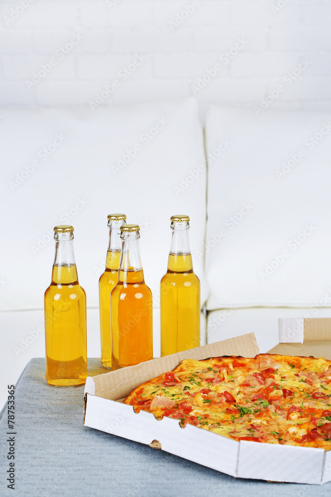 Table at home with pizza and drinks for friends