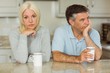 Mature couple having coffee together not talking