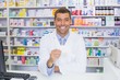 © WavebreakMediaMicro - Handsome pharmacist holding paper