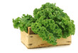  kale cabbage in a wooden crate on a white background