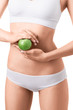 © chettythomas - Slim woman in white underwear with green apple at her hands over