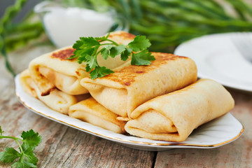 Stuffed pancakes crepes with meat and sauce