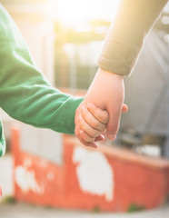 Wall Mural - Holding Hands. Mother holds her son's hand.