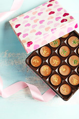 Wall Mural - Gift box with tasty chocolate candies on wooden table