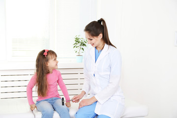 Wall Mural - Little girl and young doctor in hospital