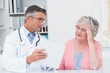 © WavebreakmediaMicro - Doctor explaining prescriptions to tensed senior woman